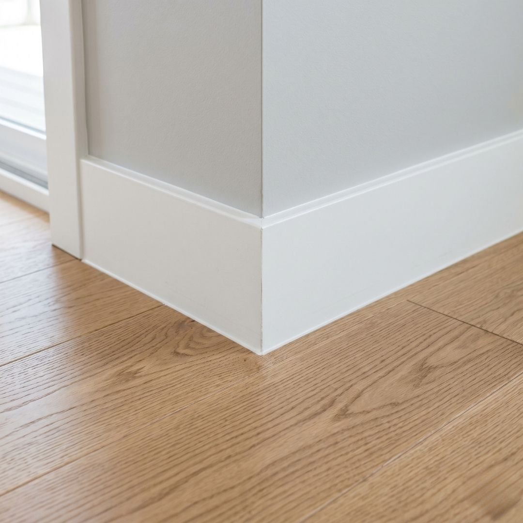 High-quality hardwood flooring installation with clean baseboard trim.