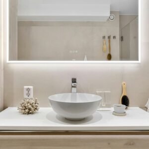A close-up of a contemporary, backlit LED bathroom mirror